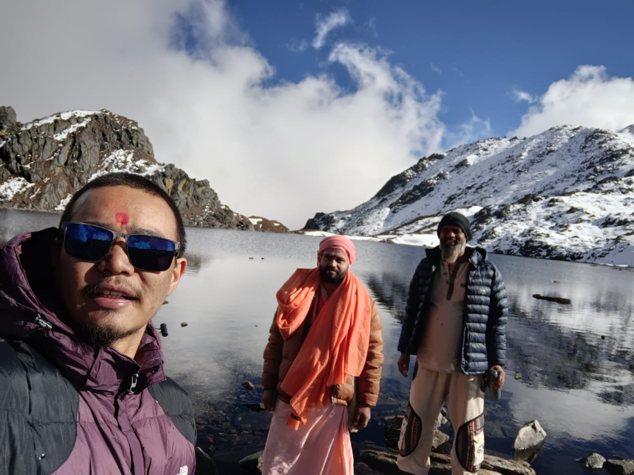 Arjuna and students beside a sacred alpine lake during a Himalayan yoga retreat in Nepal